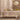 Garnier-Thiebaut Mille Pistils Naturel tablecloth pictured on a dining table filled with glassware, serveware and dinnerware.