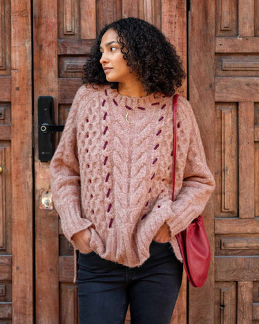 MERSEA’s Ribbons and Romance Collection sweater in Antique Rose. This chunky yet lightweight sweater features contrasting ribbon detail on a lighter background.