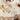 Garnier-Thiebaut ‘Vintage Flowers Cranberry’ tablecloth shown with flatware on a table.