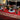 Red and brown holiday tablecloth with white plates and black bowls
