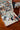 Paint-by-number kit with 'It's a Beautiful Day to Paint' text on the cover, displayed on a wooden surface.