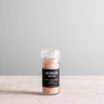 Jar of Jacobsen Salt Co. pink Himalayan salt on a light gray background