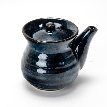 Blue ceramic teapot with a lid on a white background