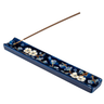 Decorative incense holder with floral design on a white background