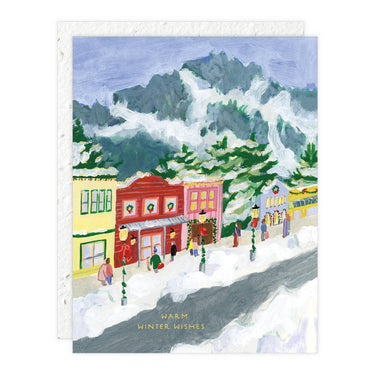 Illustration of a snowy village scene with mountains in the background, featuring colorful buildings and people.