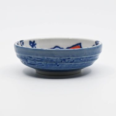 Blue ceramic bowl with decorative patterns on a white background