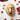 Grape hand cream on a marble background with grapes around the bottle