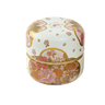 Decorative ceramic box with floral patterns on a white background