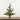 Small potted Christmas tree with pinecones on a wooden surface and white wooden panel background
