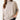 Woman wearing a beige sweater on a white background