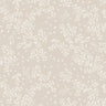 A tablecloth with a floral pattern in shades of cream and grey, displayed on a set table with dishes and decorative items.