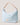 Light blue handbag with beige strap and logo on a light background