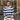 Woman wearing a blue and white striped sweater sitting in front of a window.