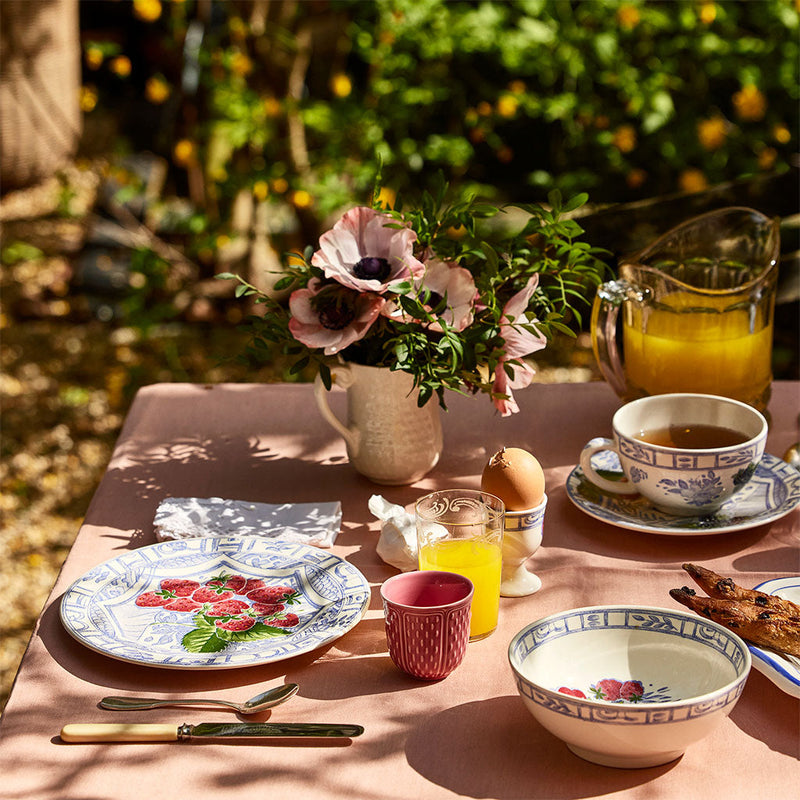 Table set with plates, espresso mugs, juice, teacups, and cereal bowl