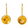 A pair of gold drop earrings with round, faceted yellow gemstones in bezel settings, shown against a plain white background.