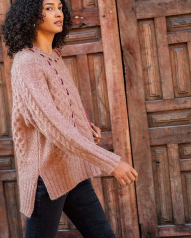 MERSEA’s Ribbons and Romance Collection sweater in Antique Rose. This chunky yet lightweight sweater features contrasting ribbon detail on a lighter background. One size and side slit detail.