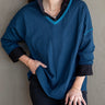 Delmar V-Neck Sweater in Deep Teal shown worn over a black collared shirt