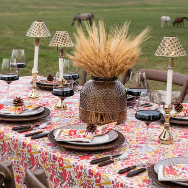 Garden Sunset Collection Tablecloth shown with dinnerware and floral accessory