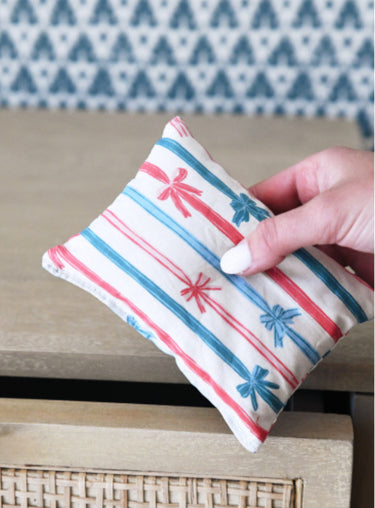 Lavender sachet with cream cotton cover featuring blue and red ribbons
