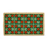 Floral patterned doormat with red and white flowers on a green background